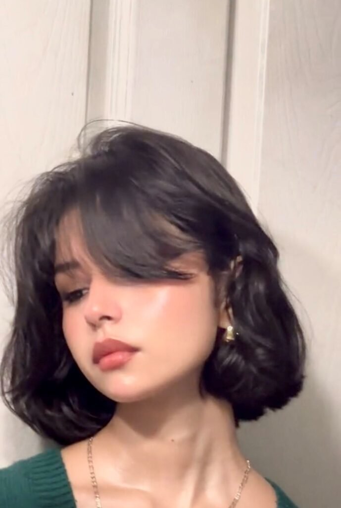 13. (Voluminous Dark Brown Wavy Bob with Side-Swept Bangs)