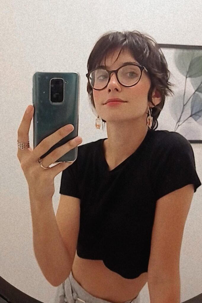 5. Shaggy Dark Brown Pixie Cut with Wispy Bangs and Glasses