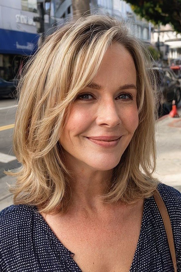 1. Layered Blonde Lob with Side-Swept Bangs