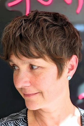 1. Short Wavy Brunette Pixie Shag with Textured Bangs