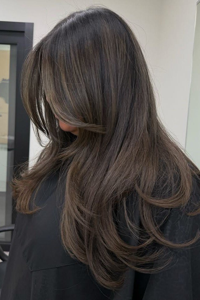 12. Long Layered Dark Brunette with Subtle Ash Brown Tone-on-Tone Balayage and Rounded Blowout