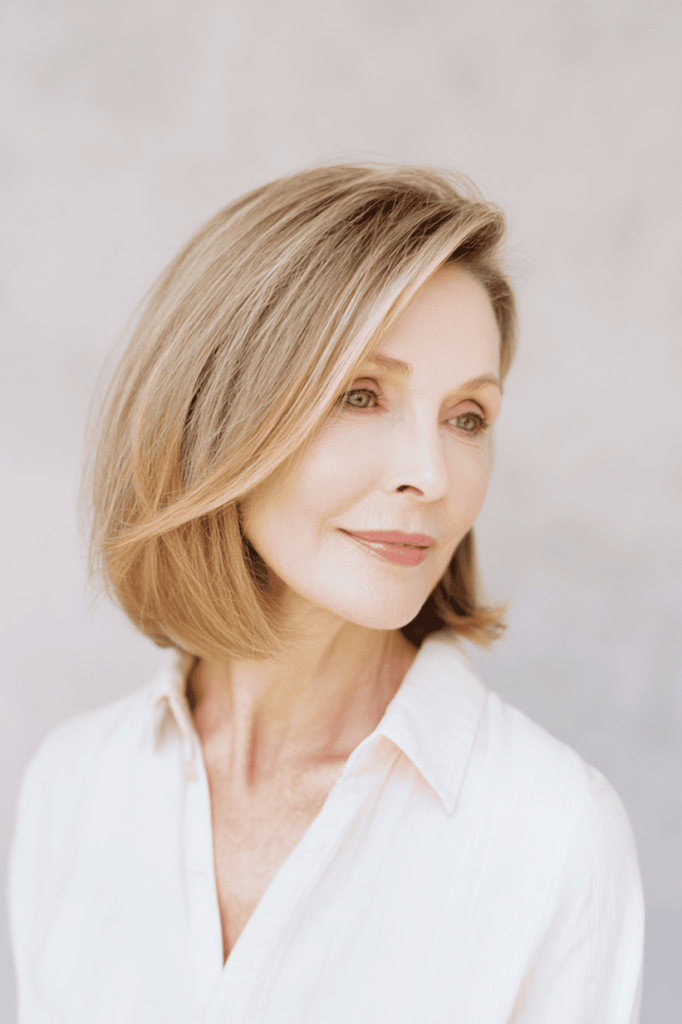 12. Sleek Side-Parted Warm Blonde Long Bob
