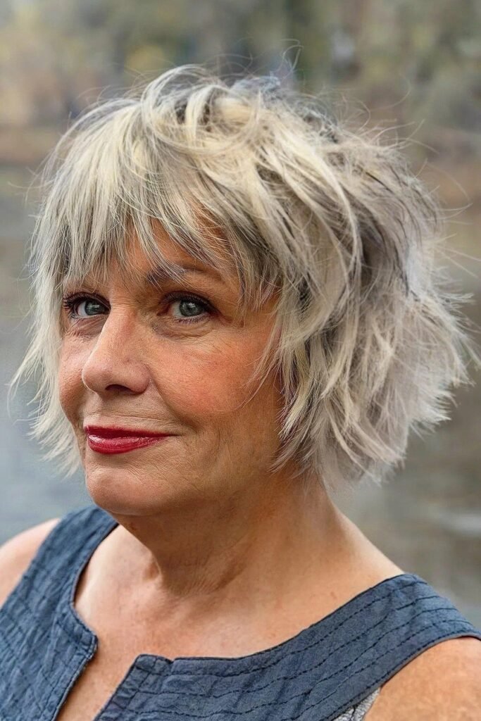 13. Messy Platinum Blonde Bob with Choppy Textured Bangs and Layered Ends