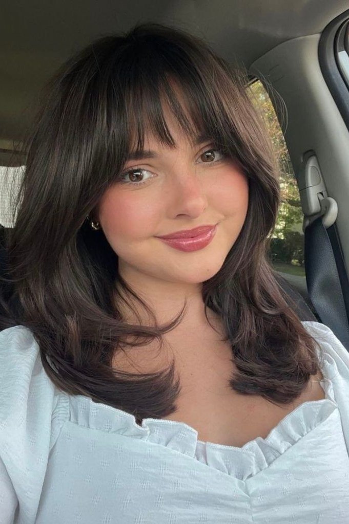 14. Medium Layered Haircut with Wispy Front Bangs