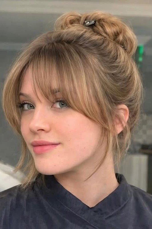 16. High Braided Bun with Soft Feathered Fringe