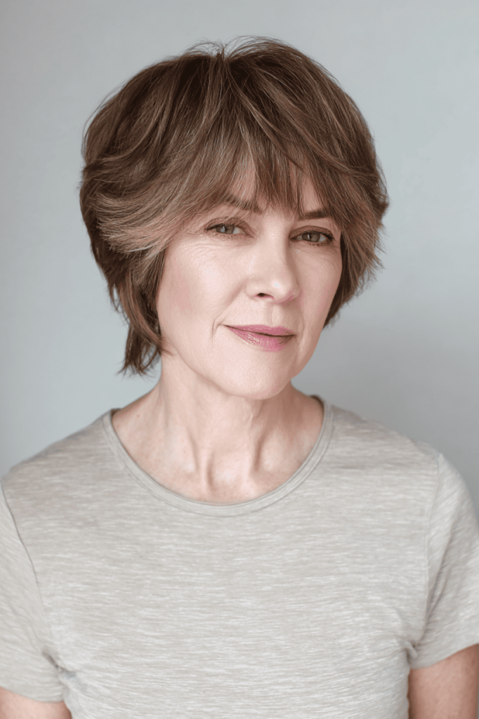 16. Soft Chestnut Brown Layered Bob with Curved Bangs