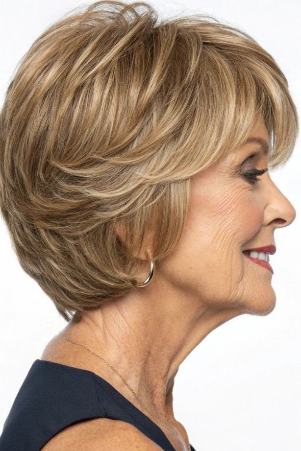 17. Layered Honey-Blonde Pixie Bob with Side-Swept Bangs