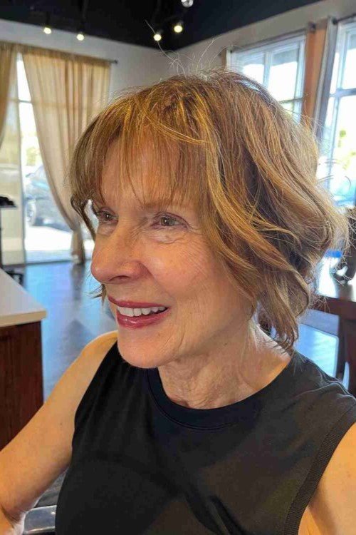 18. Wavy Warm Brown Bob with Wispy Bangs
