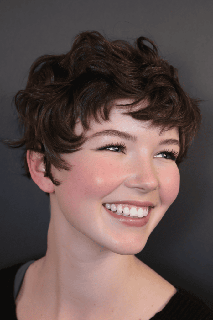 19. Soft Wavy Dark Brown Pixie Cut with Light Curtain Bangs