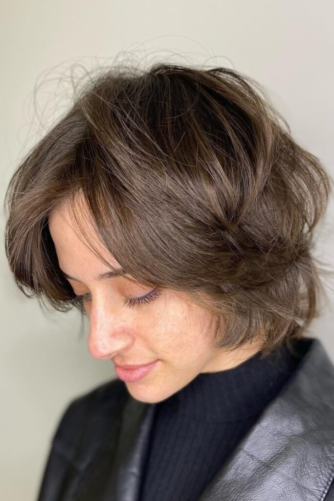 20. Casual Brunette Crop with Face-Framing Curtain Layers