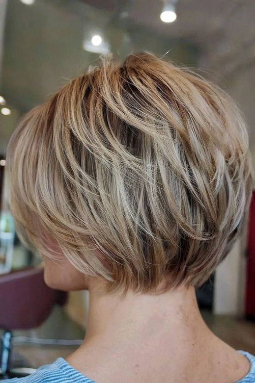 20. Layered Blonde Bob Cut with Textured Feathered Ends
