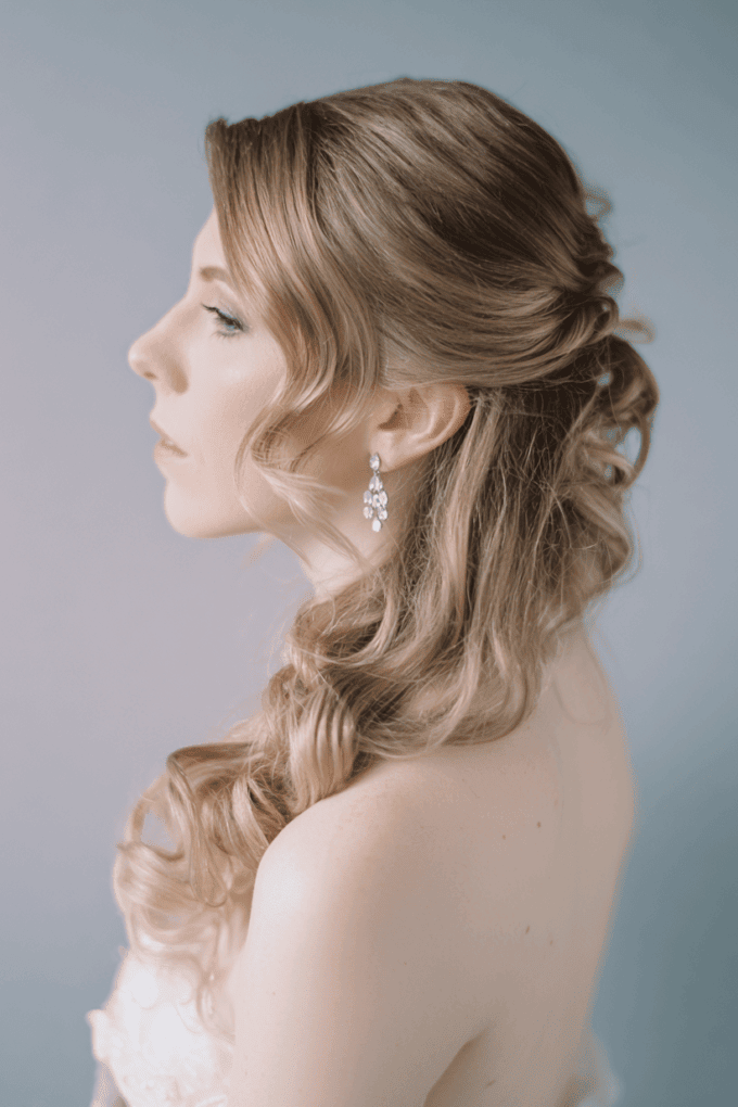 20. Romantic Side-Swept Twisted Half-Up Style with Soft Waves