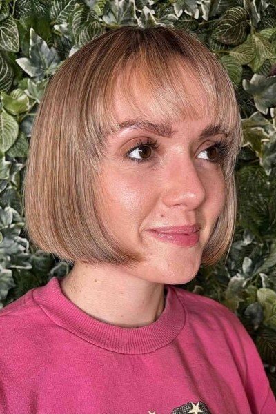 20. Straight Blunt French Bob with Soft Eyebrow-Grazing Bangs