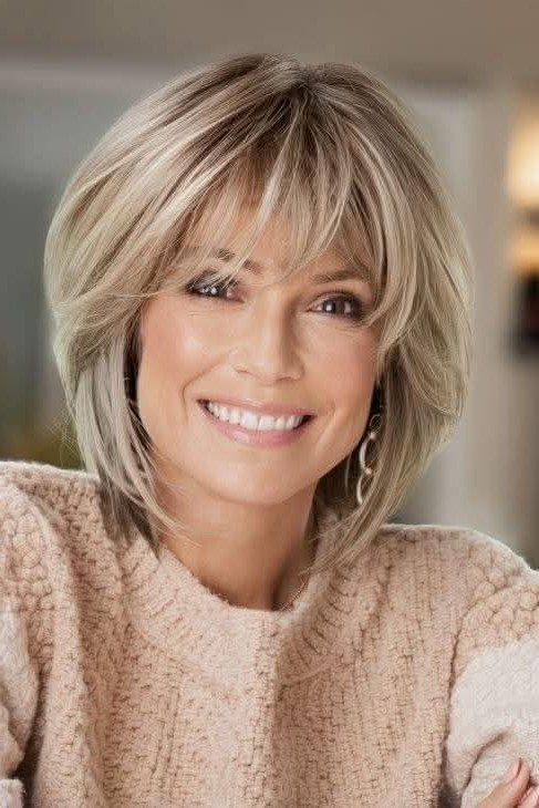 20. Voluminous Ash Blonde Rounded Bob with Layered Bangs