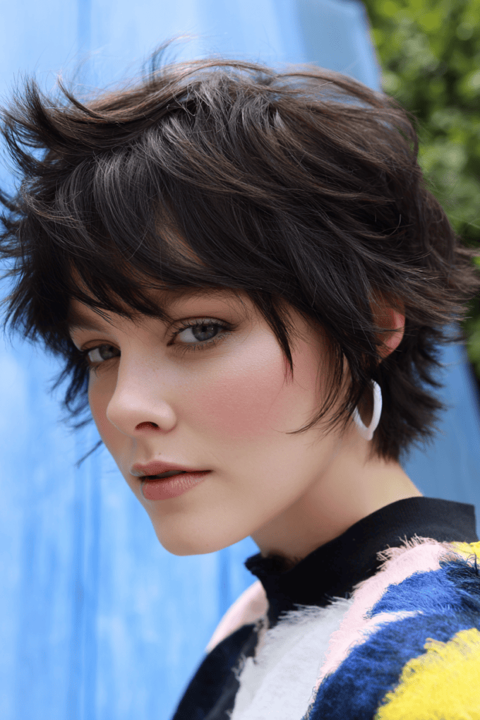 20. Voluminous Tousled Dark Brown Shag Pixie with Side-Swept Layers