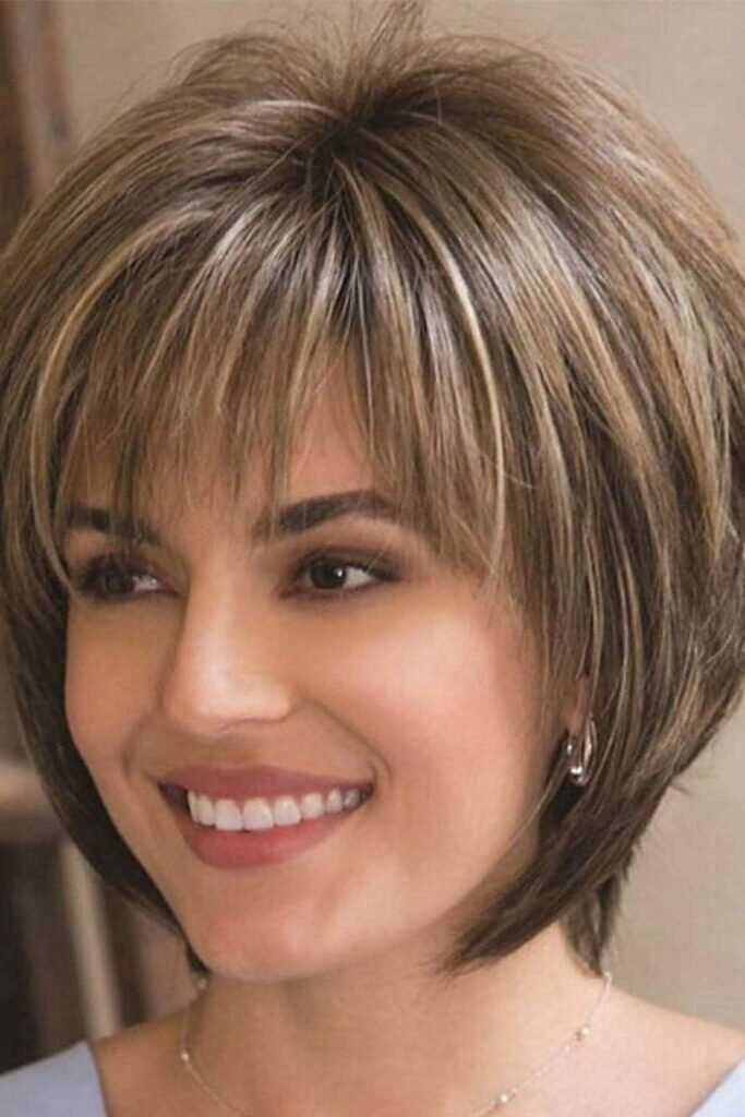 4. Layered Blonde Highlighted Bob with Wispy Bangs