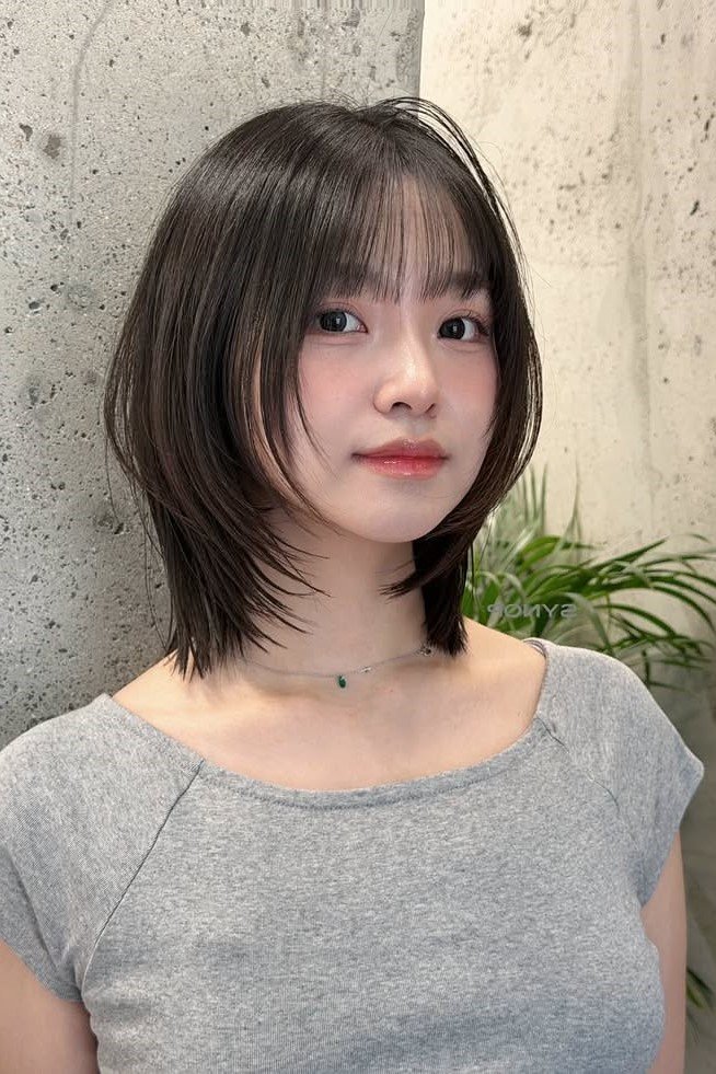 4. Straight Shoulder-Length Shag with Thin Wispy Bangs