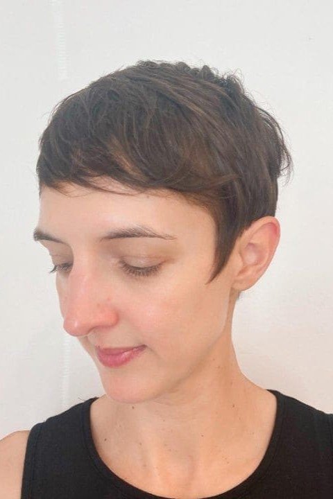 4. Ultra-Short Brunette Pixie Cut with Side-Swept Fringe