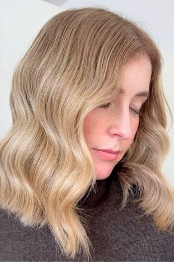 5. Softly Wavy Honey Blonde Lob with Center Part