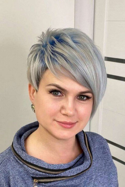 6. Asymmetrical Platinum Blonde Pixie with Blue Accents