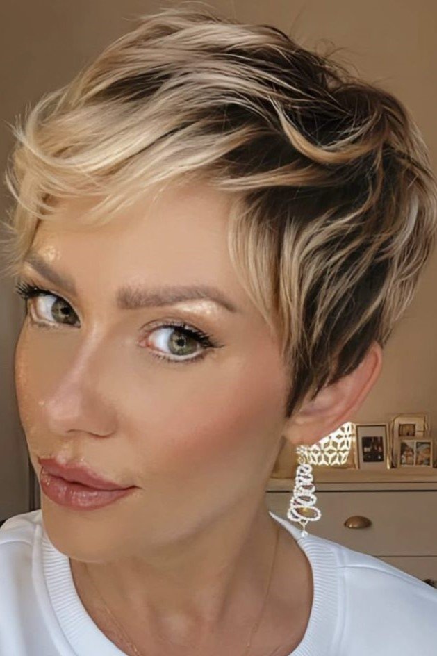 6. Layered Honey Blonde Pixie with Side Part and Dark Roots
