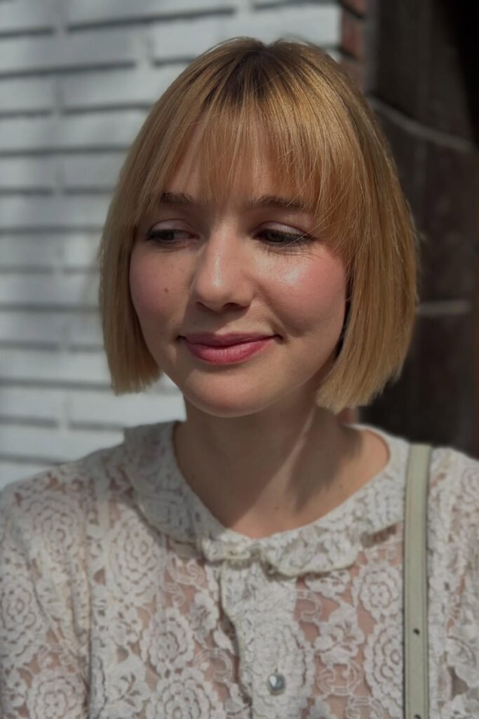 6. Straight Blonde Bob with Full Straight-Across Bangs