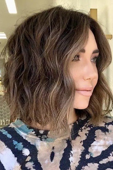 6. Tousled Dark Blonde Wavy Bob with Subtle Highlights