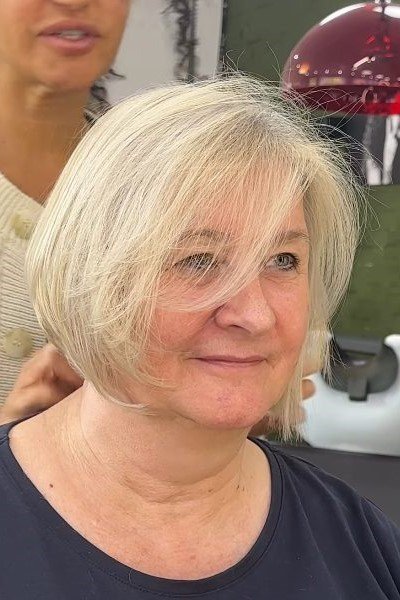 7. Feathered Blonde Bob with Wispy Side Bangs