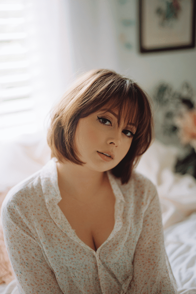 7. Soft Layered Chestnut Bob with Wispy Full Fringe