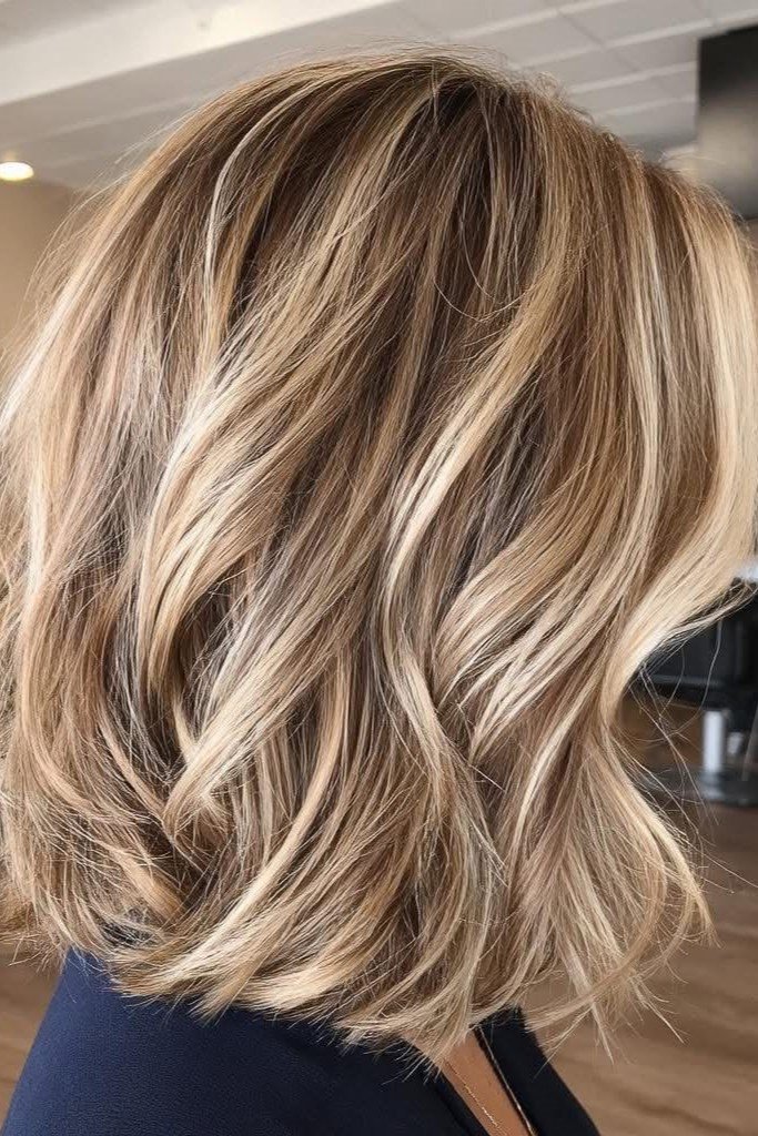 7. Tousled Honey Blonde Wavy Bob with Dimension