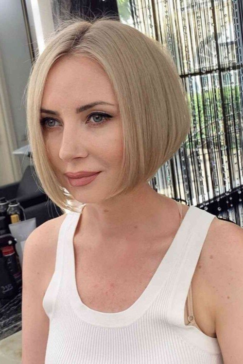 8. Platinum Blonde Center-Parted Sleek Bob