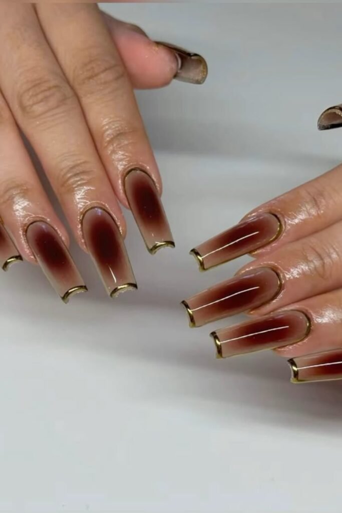 17. Espresso Aura Coffin Nails with Gold Chrome Outline