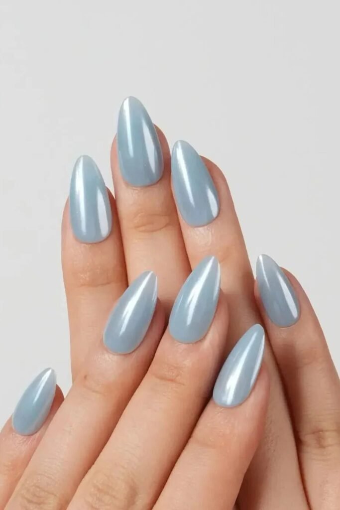 17. Soft Blue Almond Nails with a Surfboard Accent