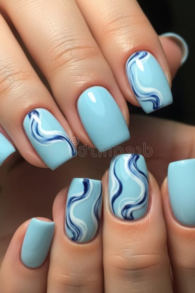 18. Sky Blue Nails with a Marble Accent