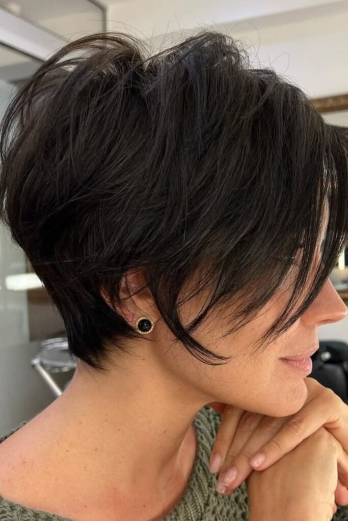 2. Layered Pixie with Long Side-Swept Fringe