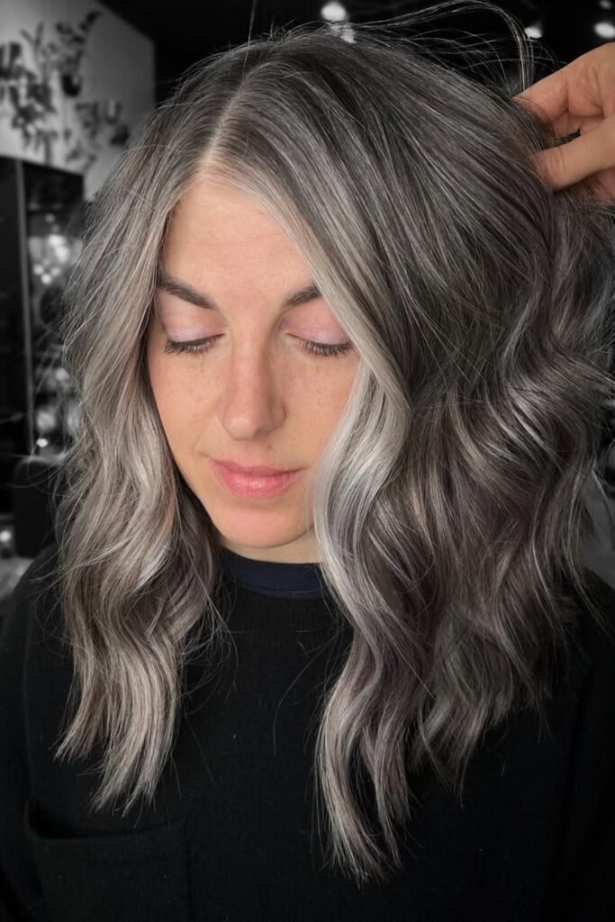 20. Sleek Gray Updo with Face-Framing Strands