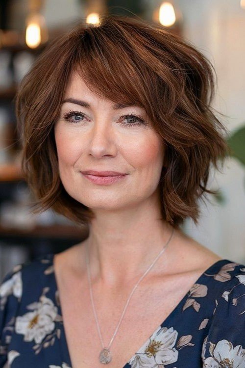 3. Tousled Warm Chestnut Bob with Side Bangs