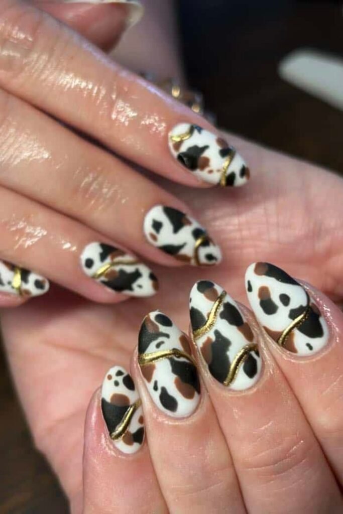 4. Cow Print French Tips with Rhinestones