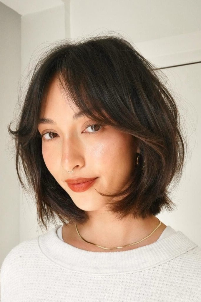 4. Dark Brunette Chin-Length Bob with Feathered Curtain Fringe