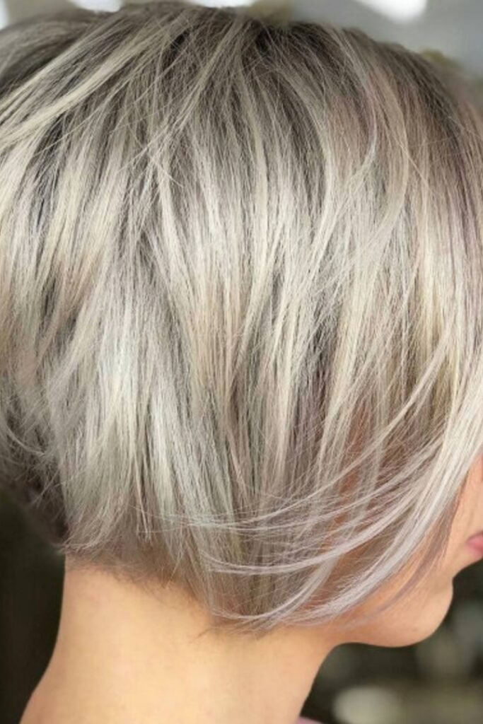 5. Deep Side Part Choppy Bob with Auburn Glints
