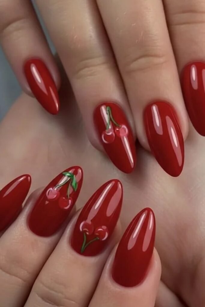 6. Glossy Red Nails with Cherry Accent Art