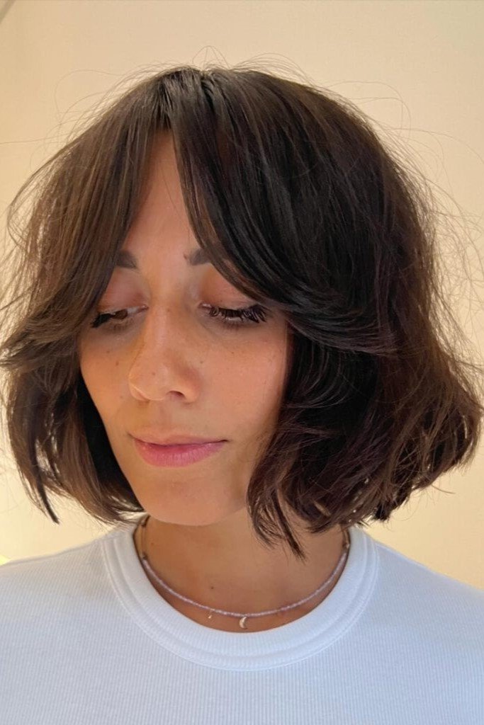 9. Dark Brown Textured Short Bob with Sweeping Center-Parted Bangs