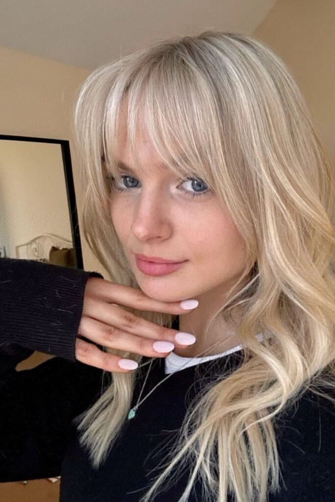 16. Cool Platinum Waves with Soft Wispy Bangs