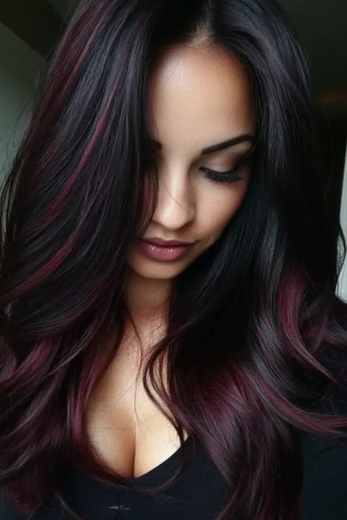 10. Long Layers with Burgundy Streaks