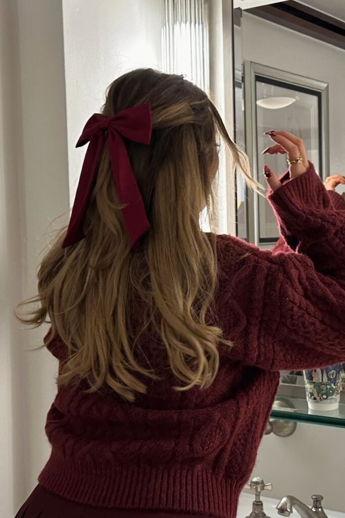 1. Cable-Knit Burgundy Sweater with Half-Up Velvet Bow