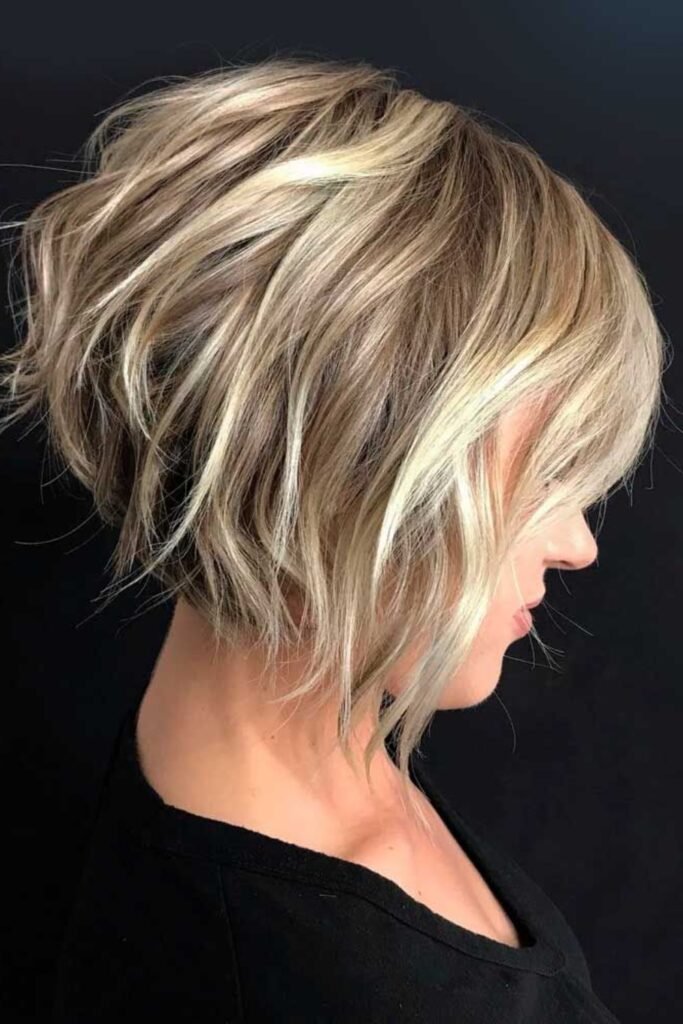2. Ash Blonde Wavy Inverted Bob with Wispy Bangs