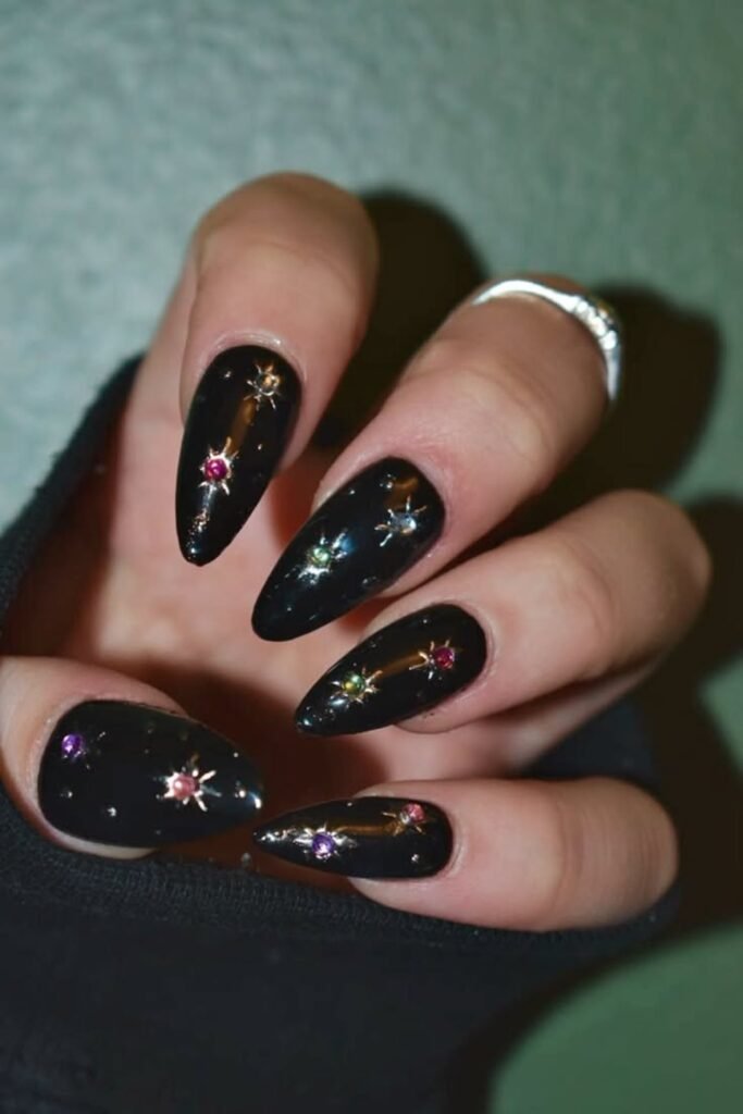 3. Black Nails with Gem Star Charms