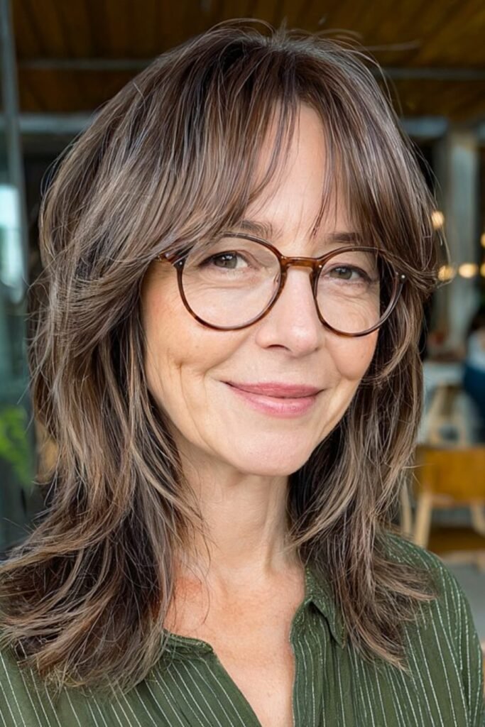 14. Textured Brunette Shag with Glasses Friendly Bangs