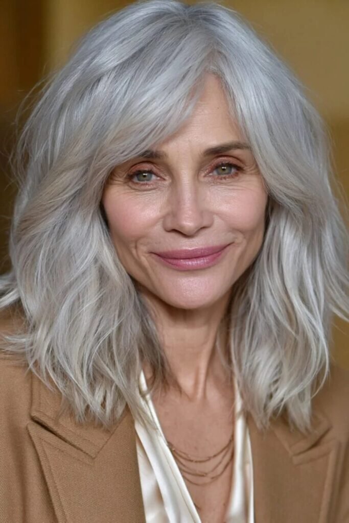 20. Tousled Bright Silver Layers with Side Swept Bangs