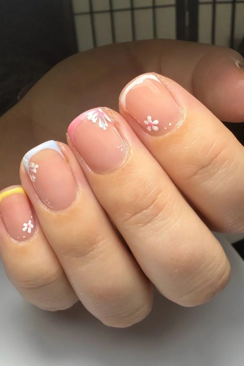 17. Pastel Rainbow French Tips with Mini Flowers